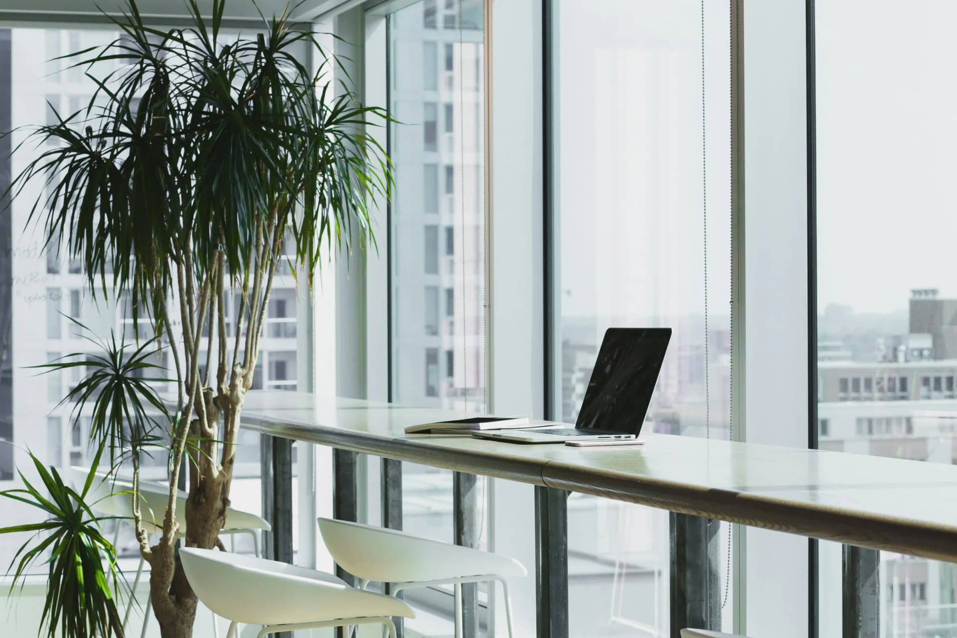 A calm modern office workspace beside a large window